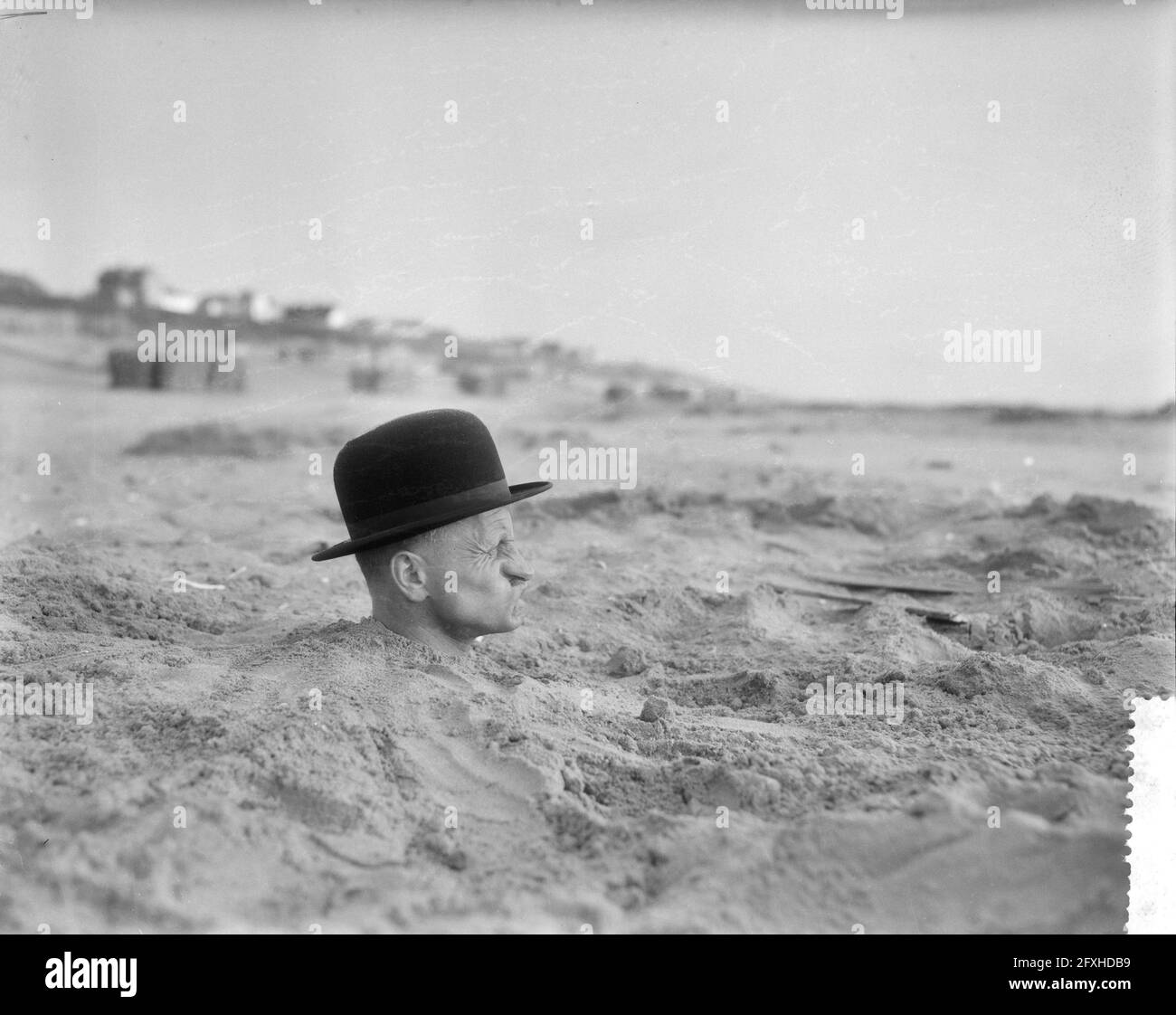 Strange situation on the Dutch beach, man with whole body in the sand, May 25, 1959, The Netherlands, 20th century press agency photo, news to remember, documentary, historic photography 1945-1990, visual stories, human history of the Twentieth Century, capturing moments in time Stock Photo