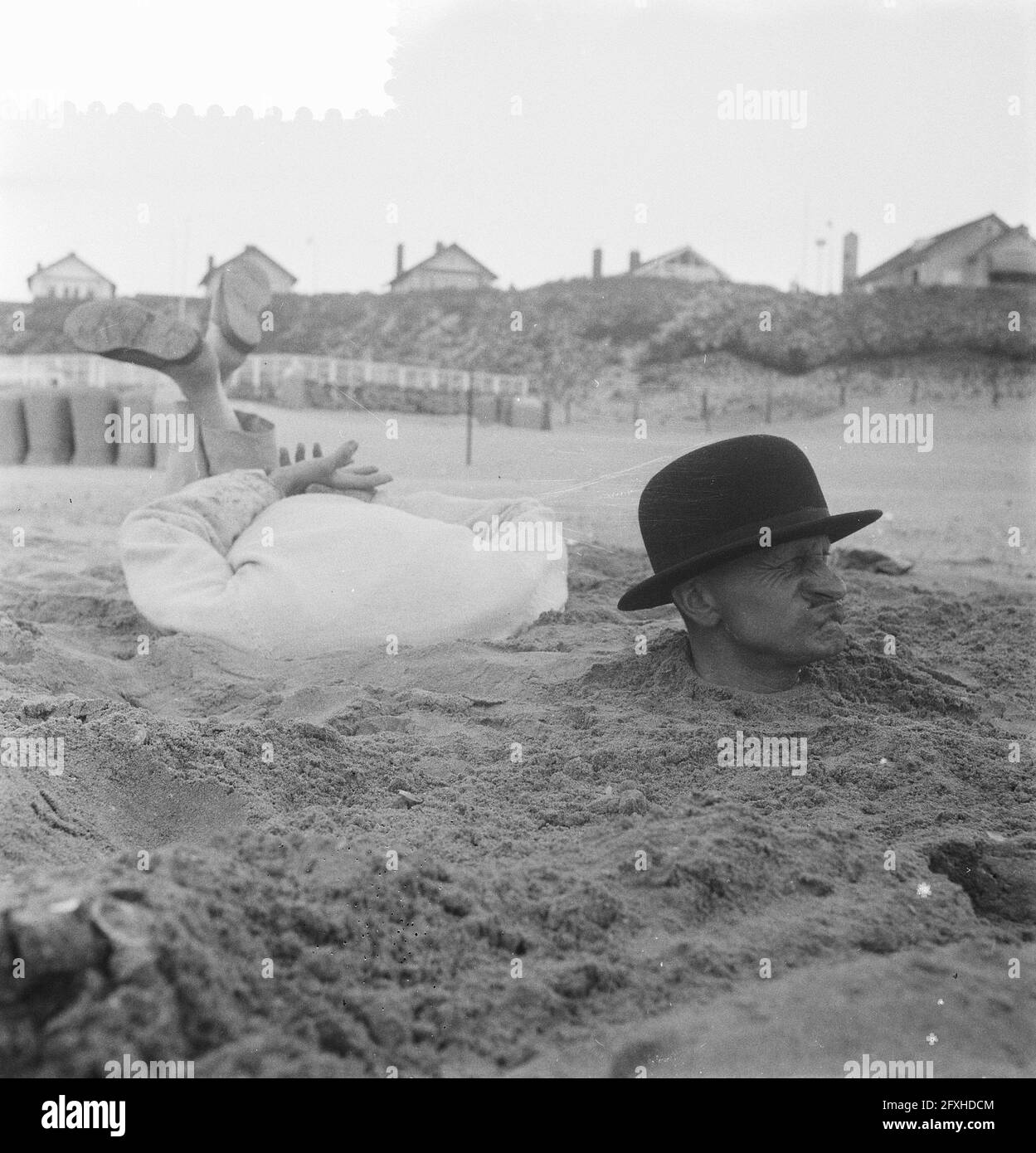 Strange situation on the Dutch beach, man with whole body in the sand, May 25, 1959, The Netherlands, 20th century press agency photo, news to remember, documentary, historic photography 1945-1990, visual stories, human history of the Twentieth Century, capturing moments in time Stock Photo