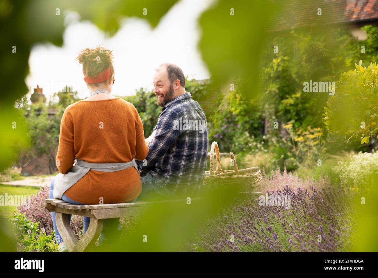 Happy couple taking a break from gardening in backyard Stock Photo