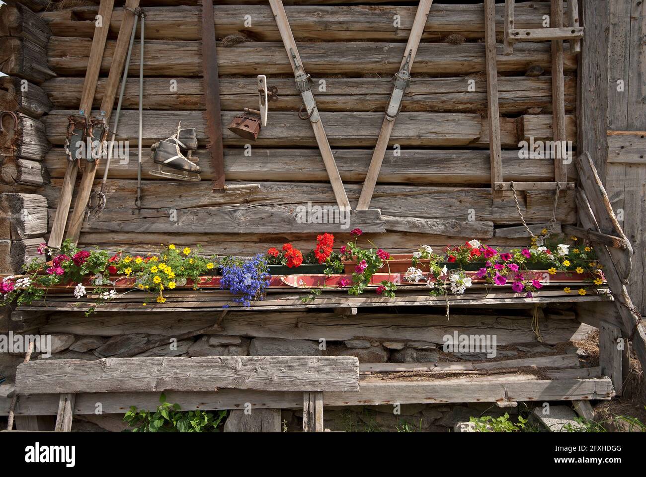 Detail of alpine cottage with old skis and ice skating boots in Passiria Valley (Passeiertal), Trentino-Alto Adige, Italy Stock Photo