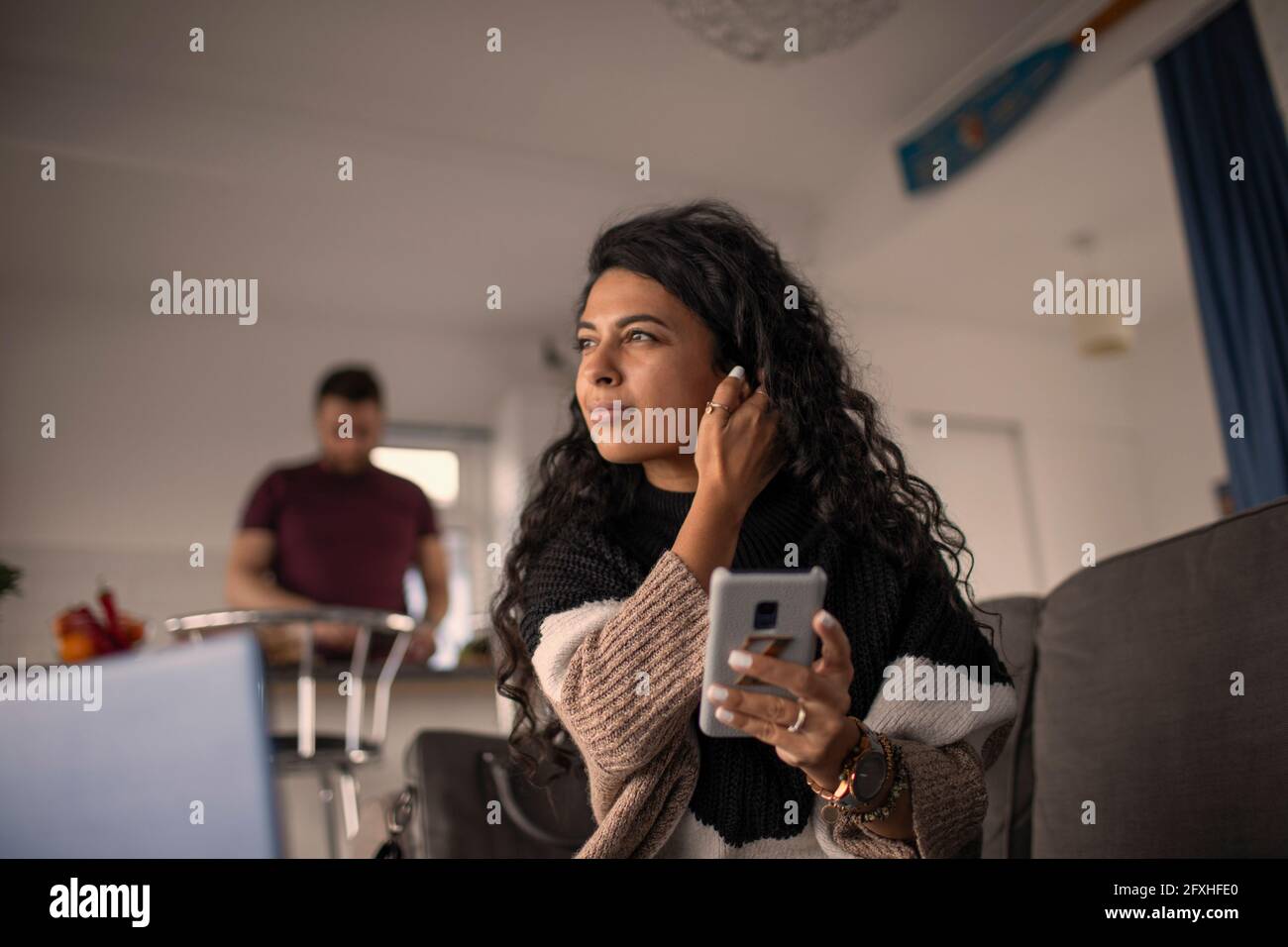 Beautiful woman using smart phone at home Stock Photo