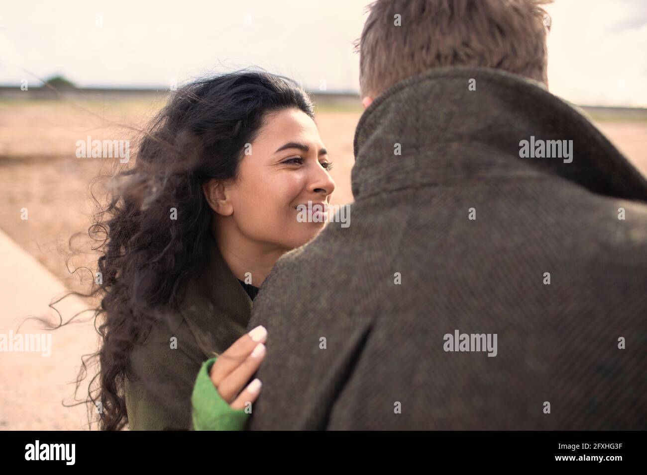 Happy woman hugging boyfriend on beach Stock Photo - Alamy