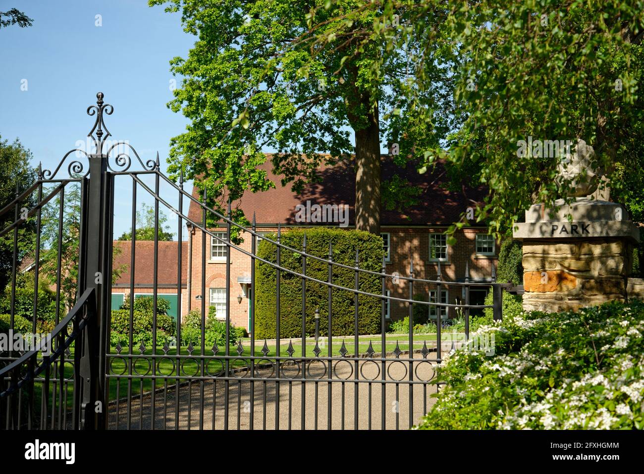 A gated development in southern England. Wrought iron electric gates to an exclusive residential