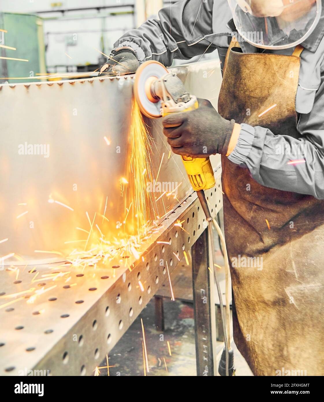 Metal cutting with angle grinder. Man welder cuts metals. Sparks in