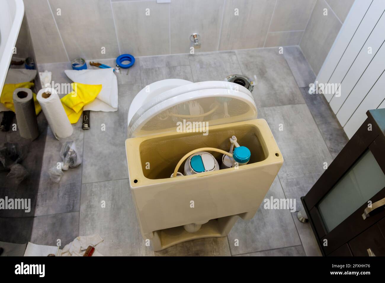 Installing a new toilet in the bathroom during repair finishing work