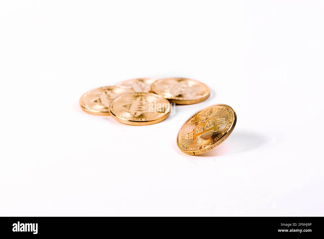 Bitcoin Crypto Currency - Golden Bitcoin Spinning In Front Of Bunch Of  Bitcoins Isolated On White Background. Copy Space. Virtual money concept.  Minin Stock Photo - Alamy
