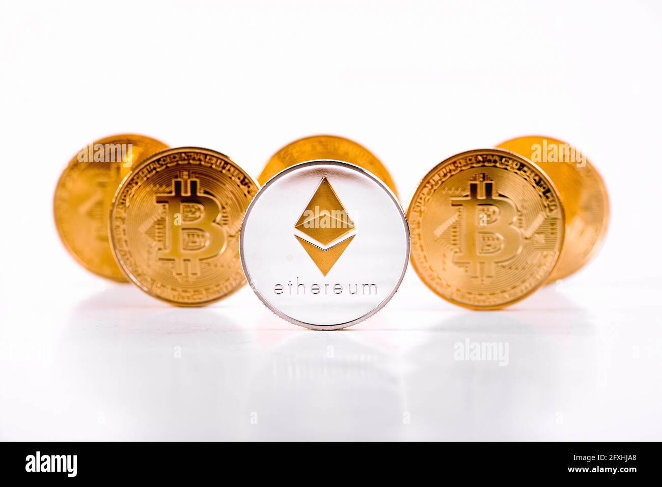 Crypto Currency Ethereum Coin Standing In Front Of Golden Bitcoins On White  Background. Ethereum Domination Concept. Cryptocurrency Stock Market Conce  Stock Photo - Alamy