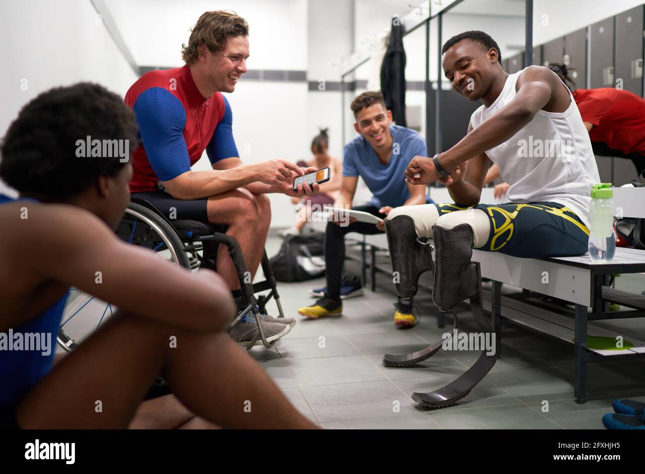 Amputee and wheelchair athletes in locker room Stock Photo