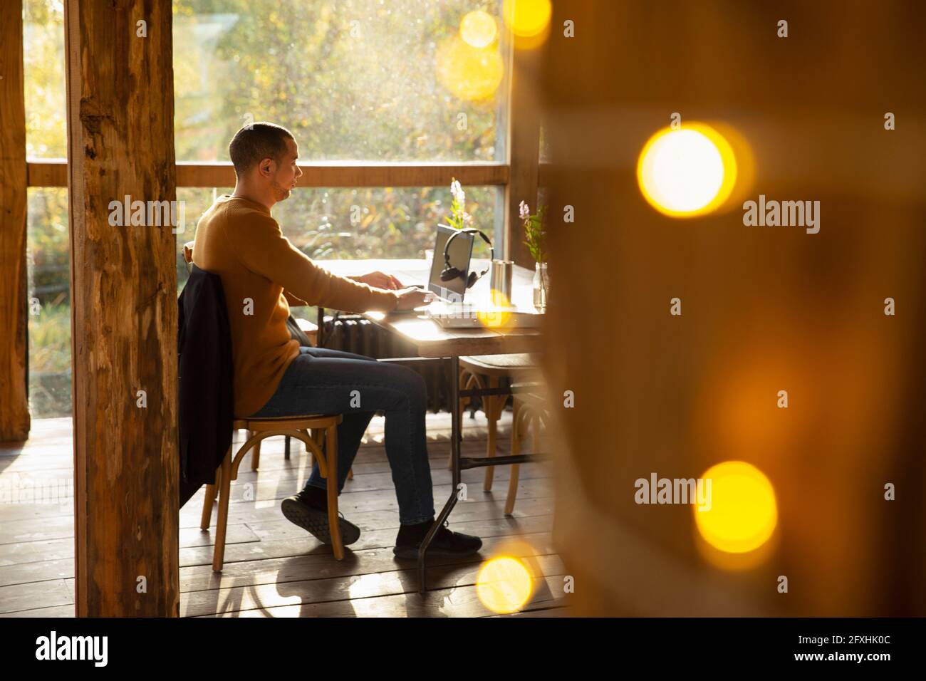 Businessman working at laptop at cafe table Stock Photo