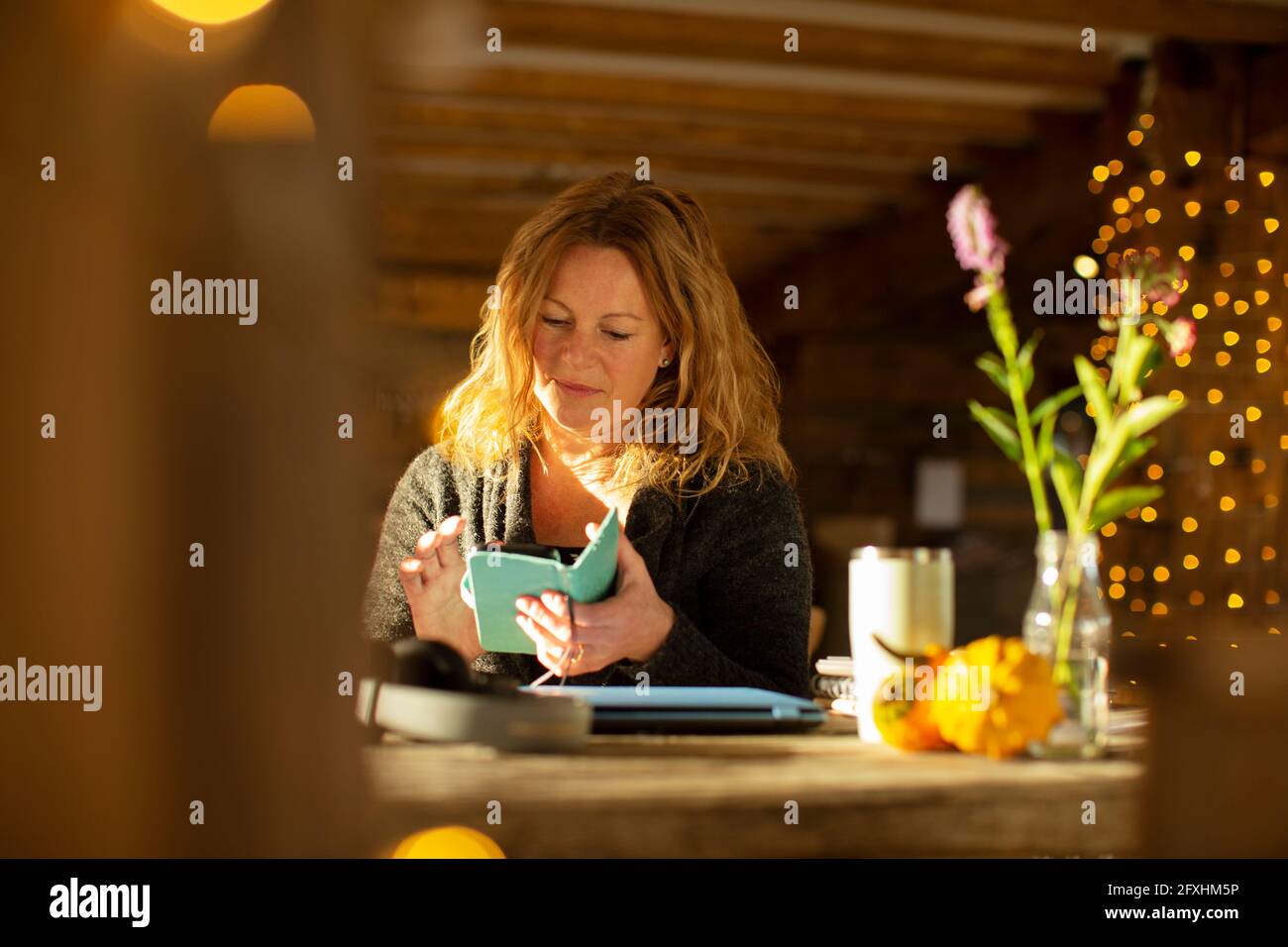 Businesswoman using smart phone at cafe table Stock Photo