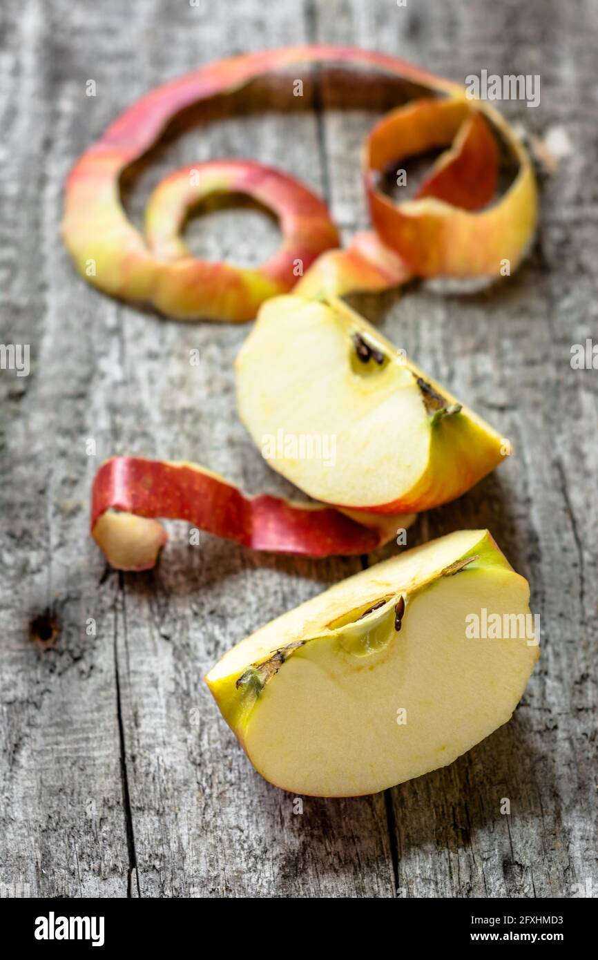 Two apple quarters with peeled peel on rustic table Stock Photo Alamy