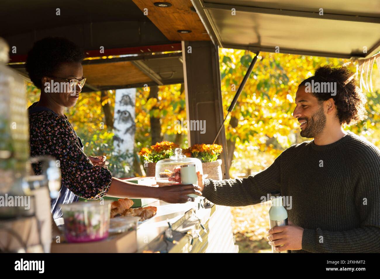 Food cart owner serving coffee to customer Stock Photo