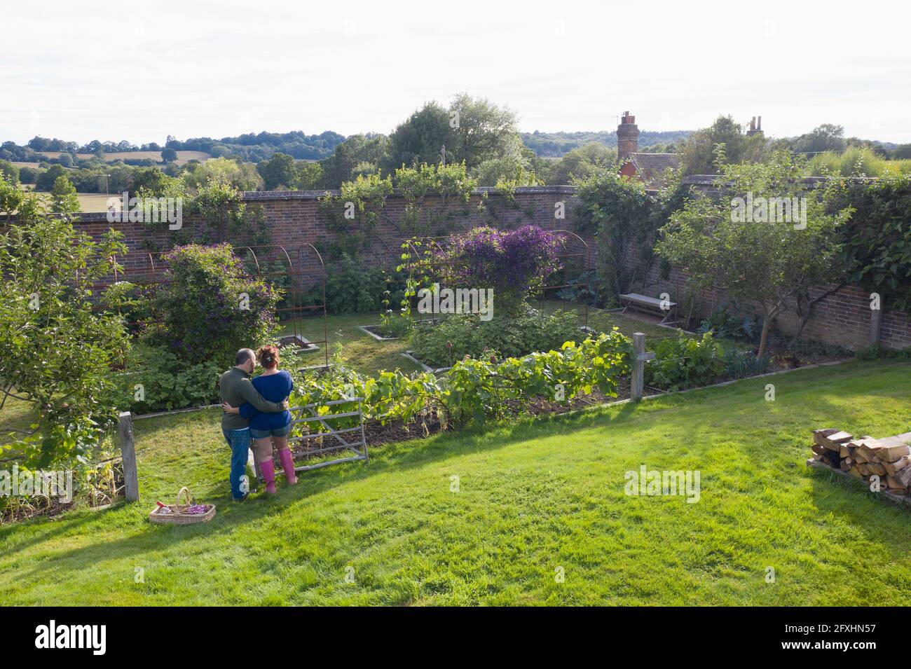 Affectionate couple in lush idyllic summer garden Stock Photo
