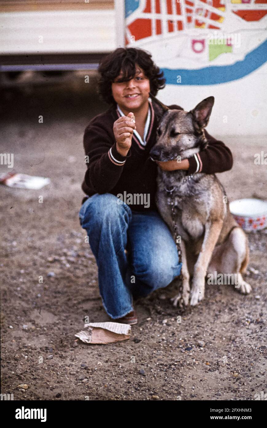A young Roma likes to be photographed with his dog Stock Photo