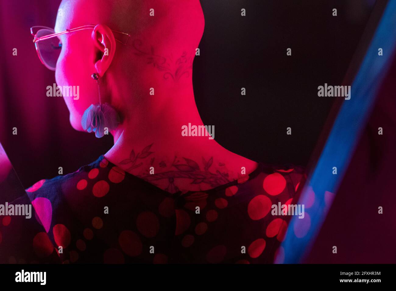 Stylish woman with shaved head and tattoos Stock Photo