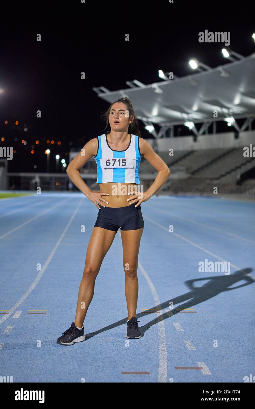 Female track and field athlete with hands on hips after competition Stock Photo