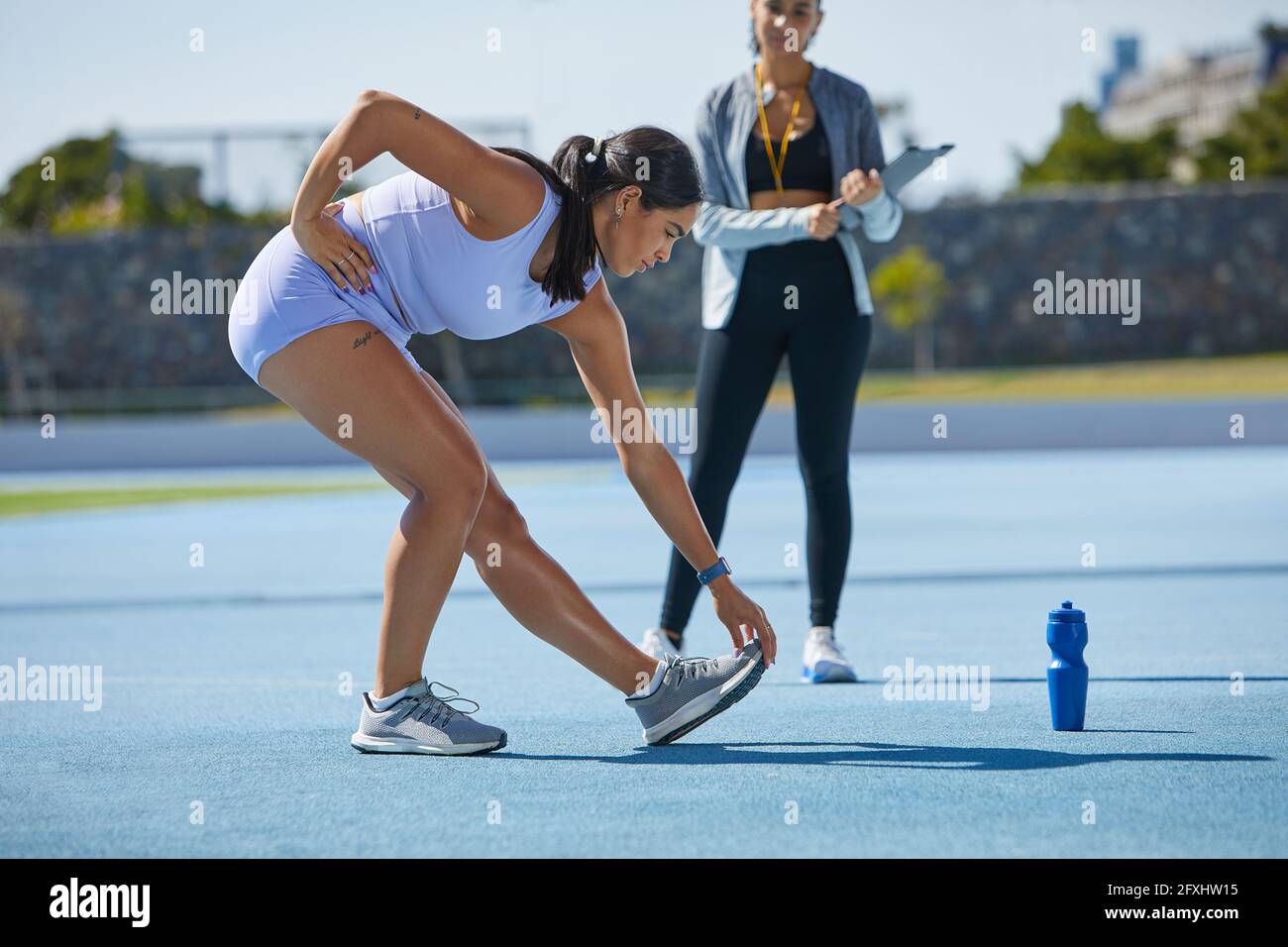 Female track and field athlete stretching Stock Photo Alamy