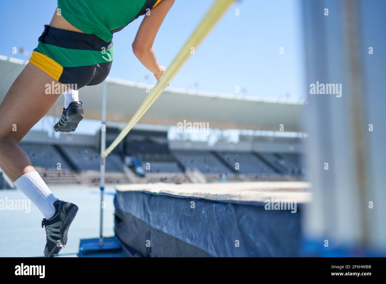 Female track and field athlete high jumping over pole Stock Photo Alamy