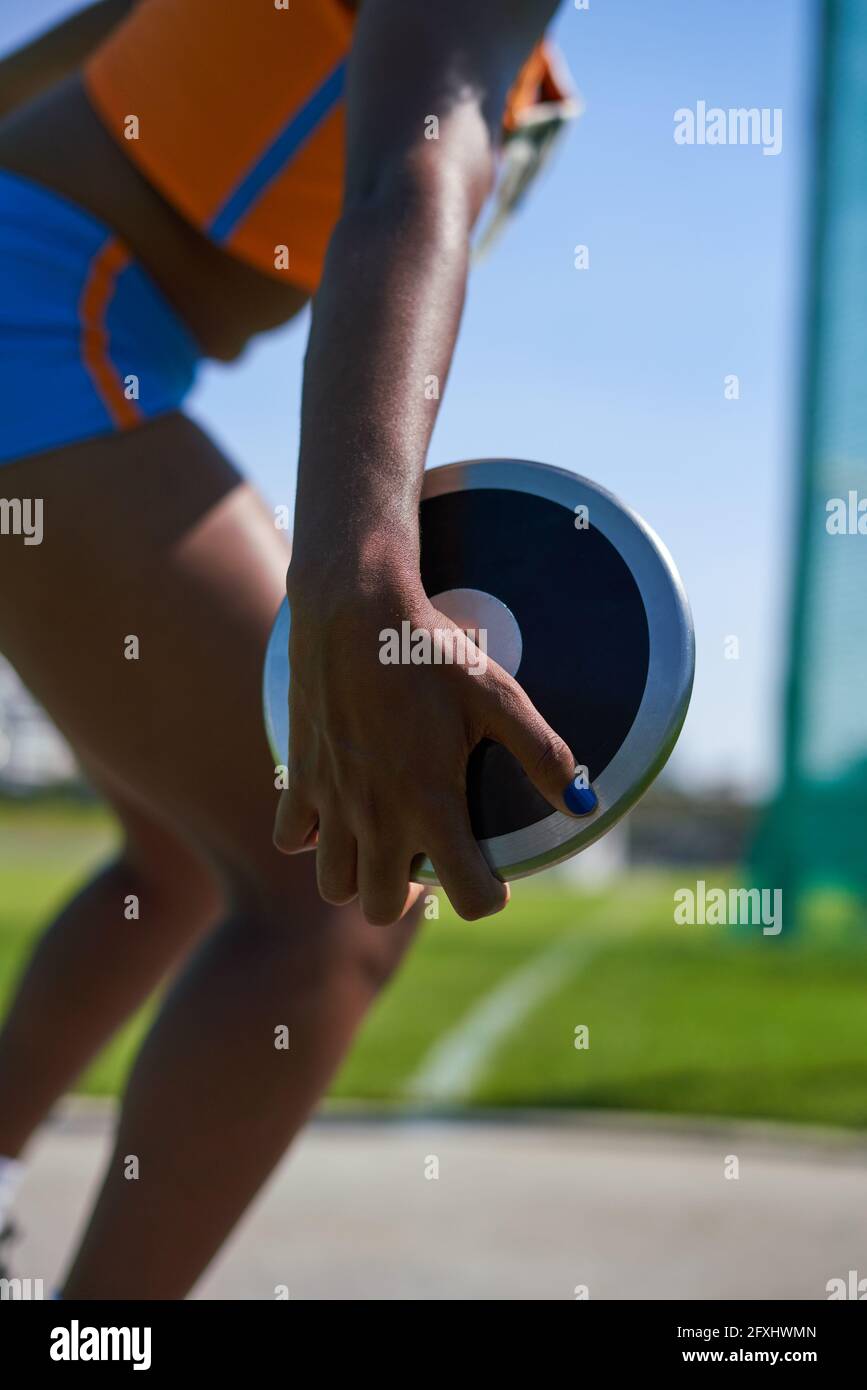 Female track and field athlete throwing discus Stock Photo