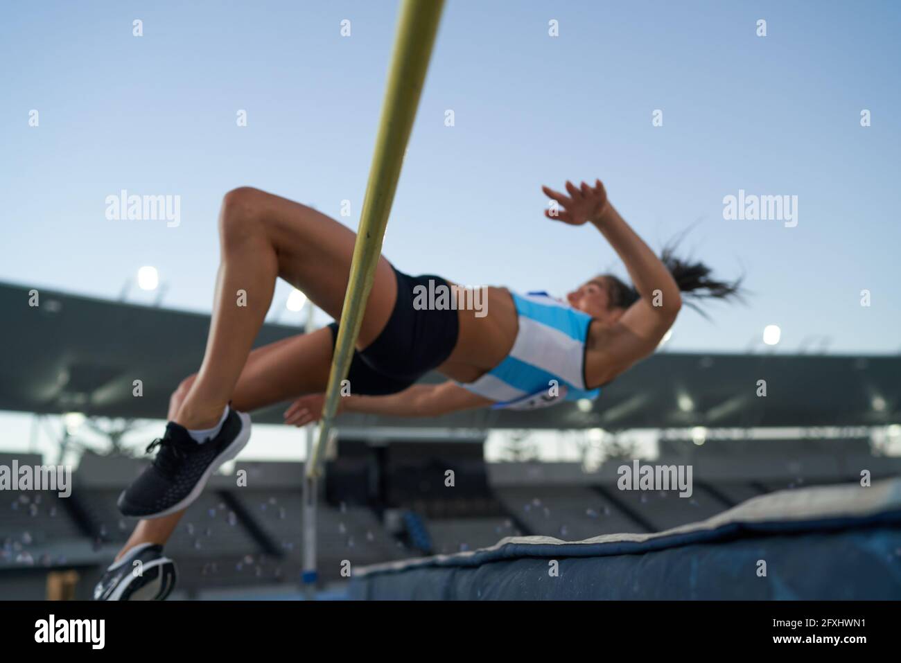 Female track and field athlete high jumping over pole Stock Photo Alamy