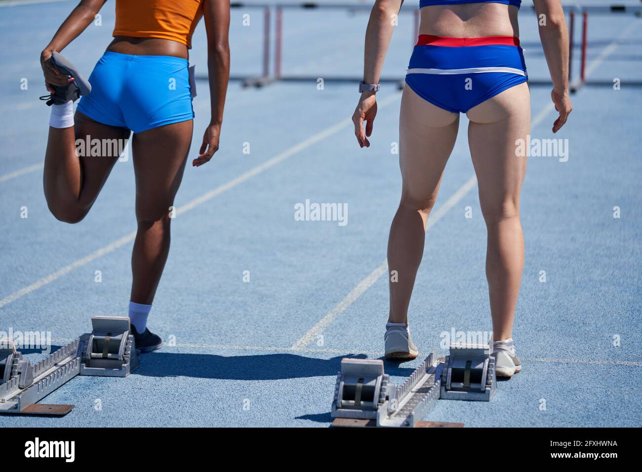 Female track and field athletes preparing at starting blocks Stock Photo Alamy