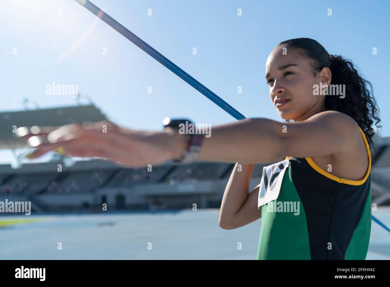 Focused female track and field athlete throwing javelin Stock Photo Alamy
