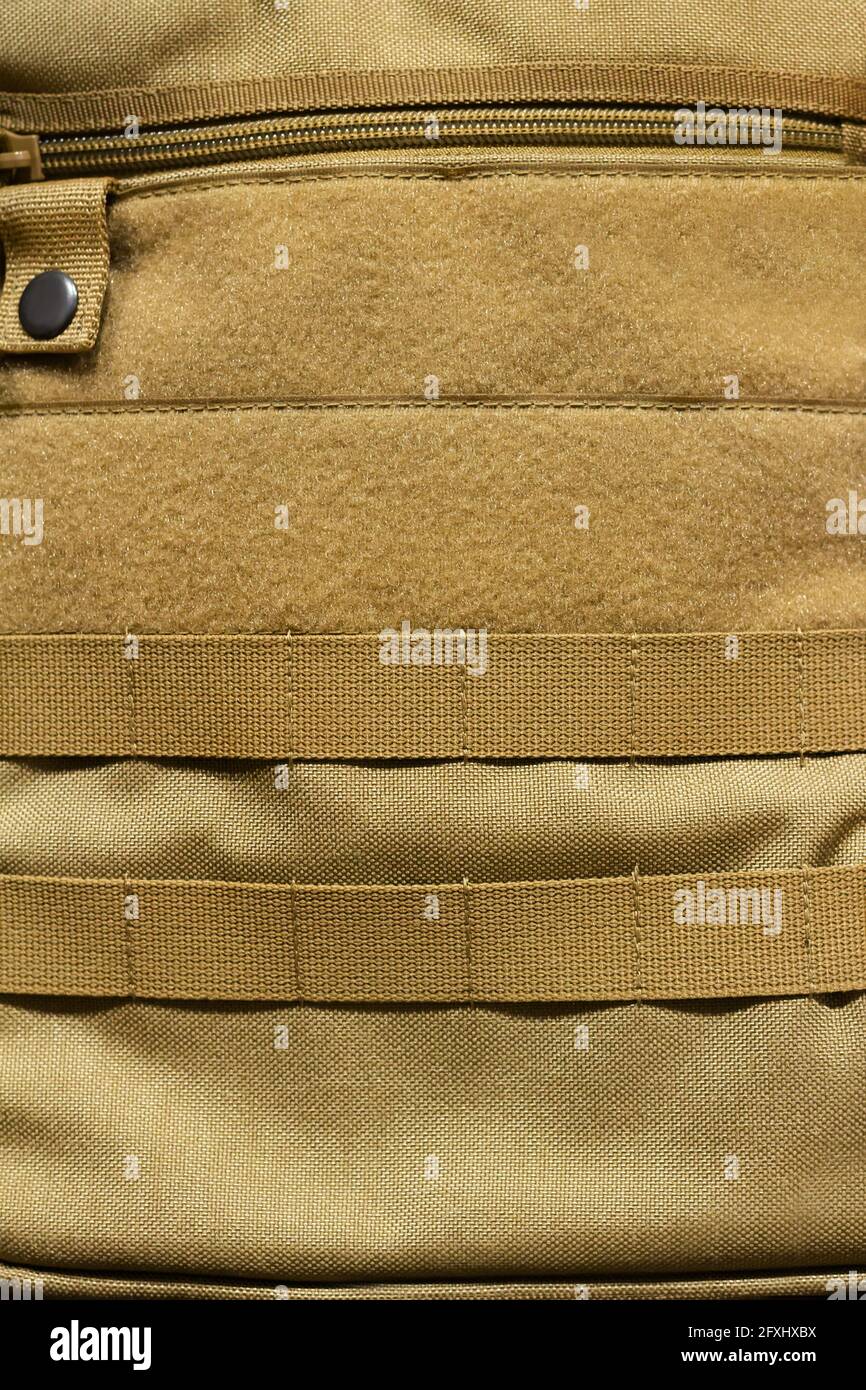 Photo of olive colored military pouch with zipper and molle stripes. Stock Photo