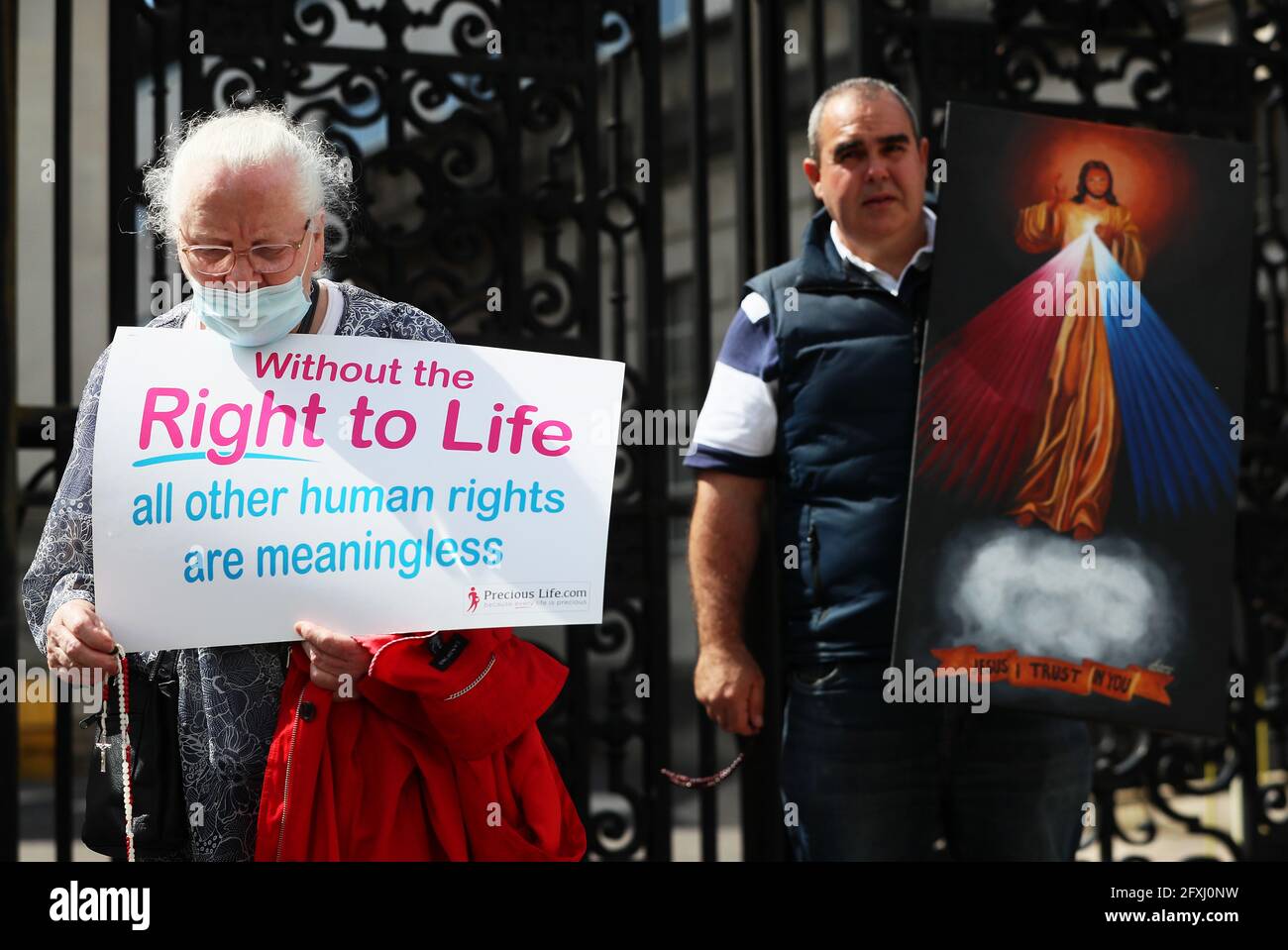 Anti abortion demonstrator prays outside Belfast High Court as a legal challenge against Northern Ireland Secretary of State Brandon Lewis, the Northern Ireland Executive and the Department of Health over the failure to commission and fund abortion services in Northern Ireland continues. Picture date: Thursday May 27, 2021. Stock Photo