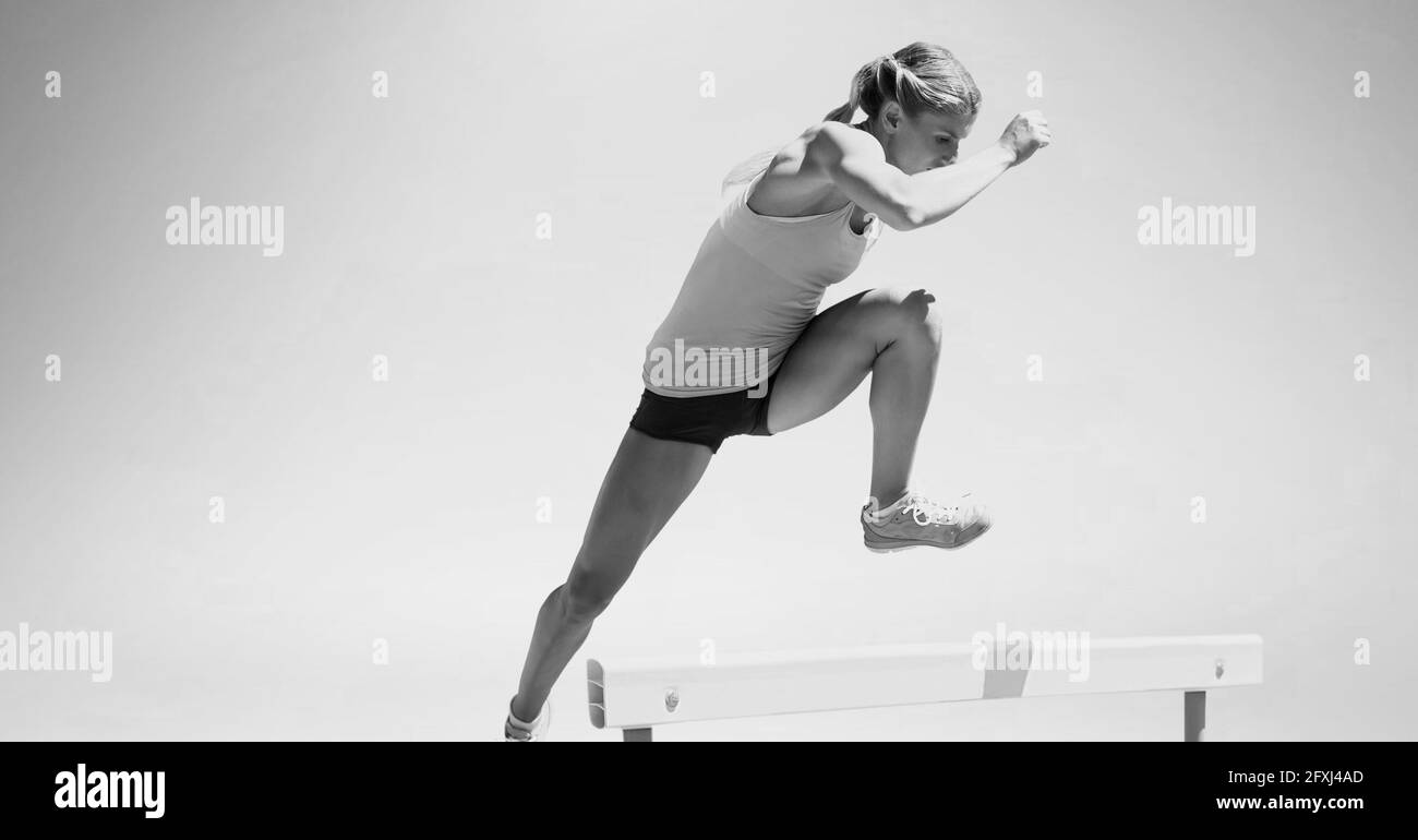 Composition of female hurdle jumper with copy space in black and white Stock Photo