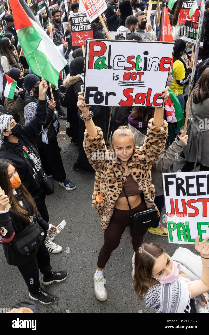 Portrait of a female protester holding 'Palestine is not for sale' placard, Free Palestine Protest, London, 22 May 2021 Stock Photo