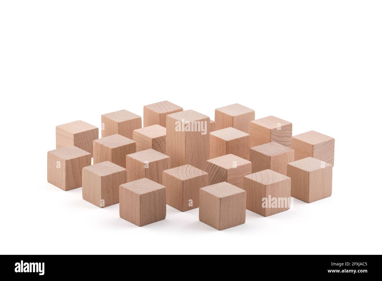 One different higher cube block among wooden blocks isolated on white with clipping path. Leadership concept. Stock Photo
