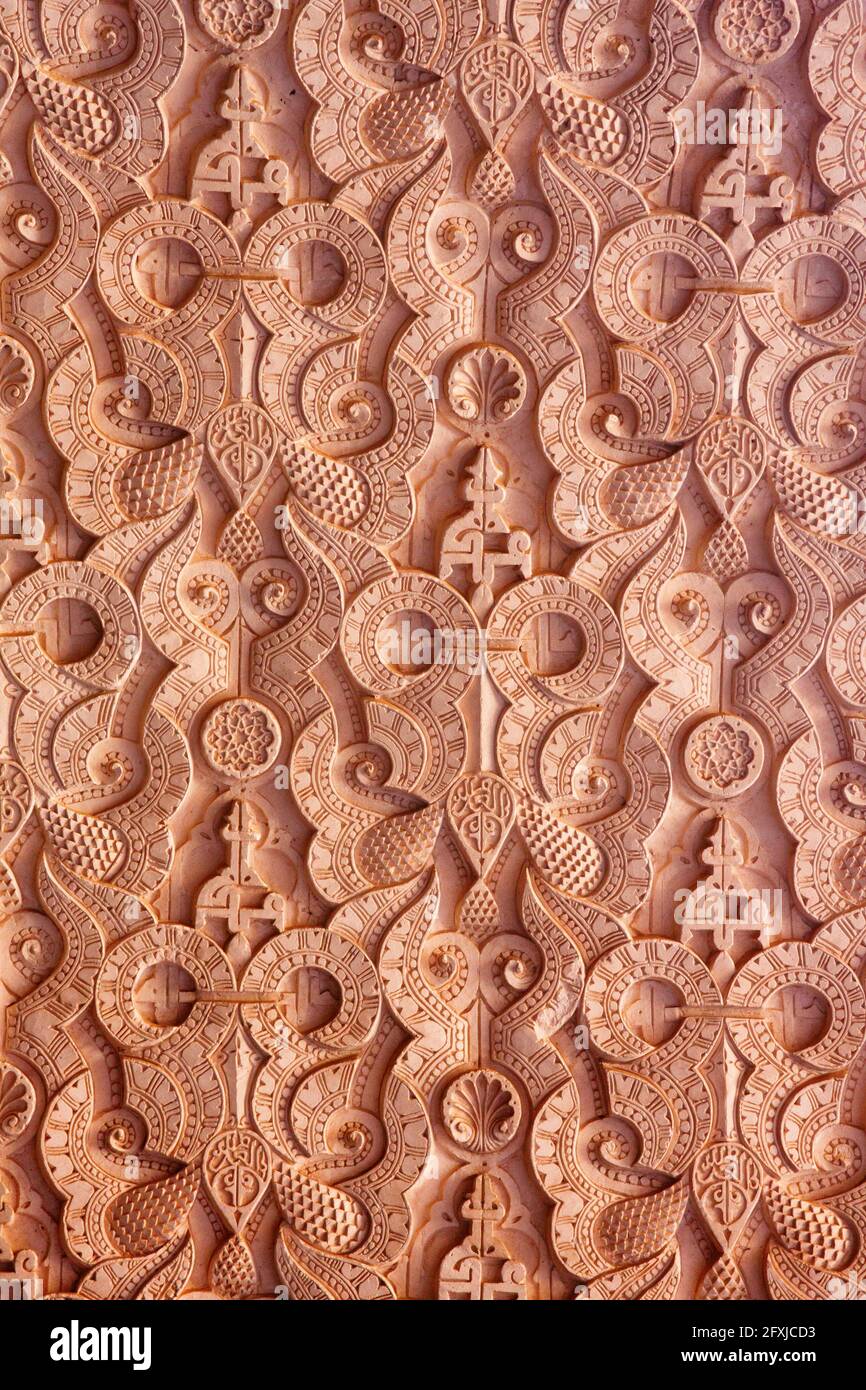 Wall in an old madrassa ornamented with a complex Arabic pattern. Marrakesh, Marocco. Stock Photo