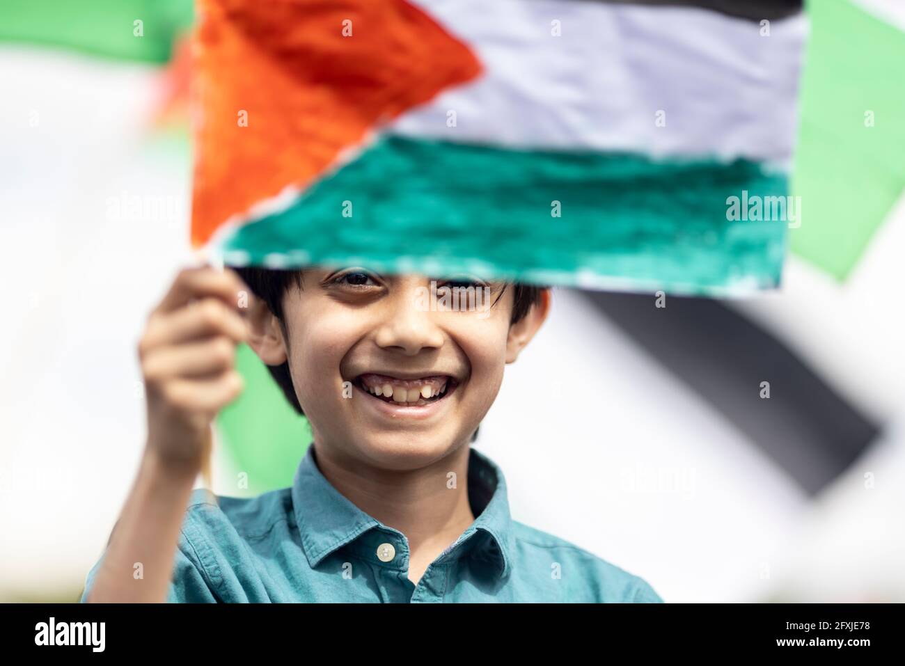 Portrait of a young boy holding up Palestinian flag, Free Palestine Protest, Hyde Park, London, 22 May 2021 Stock Photo