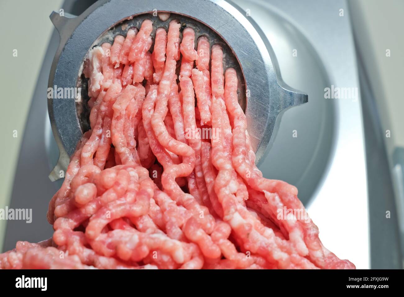 meat and grinder. Minced meat and meat grinder. Meat grinder machine  chopping uncooked ground meat Stock Photo - Alamy