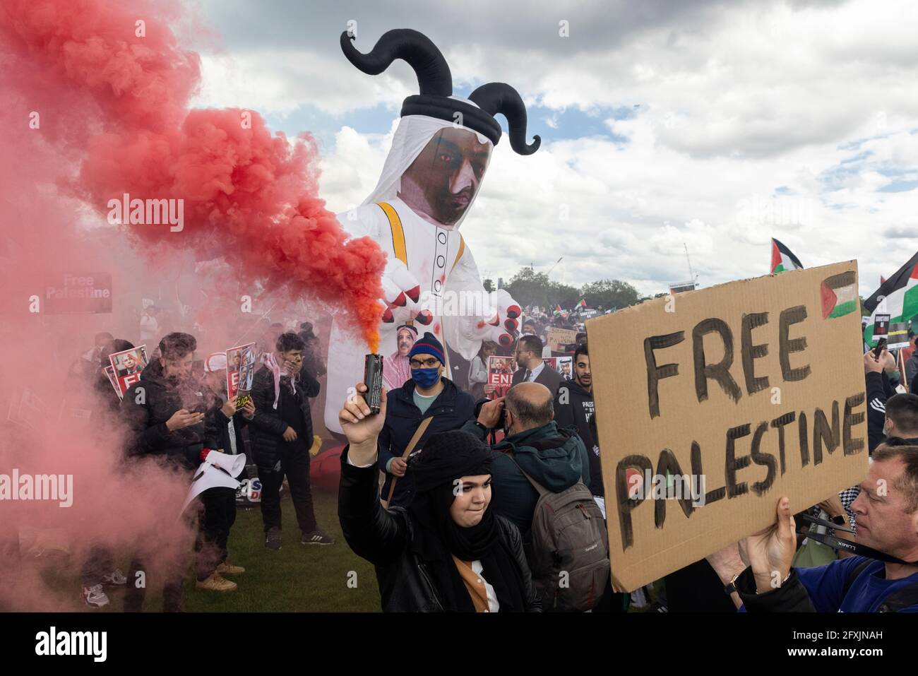 Crowd of protesters with smoke bombs and inflatable demonic figure, Free Palestine Protest, Hyde Park, London, 22 May 2021 Stock Photo