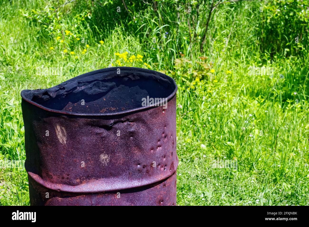 iron barrel for burning garbage in the garden, in the summer Stock