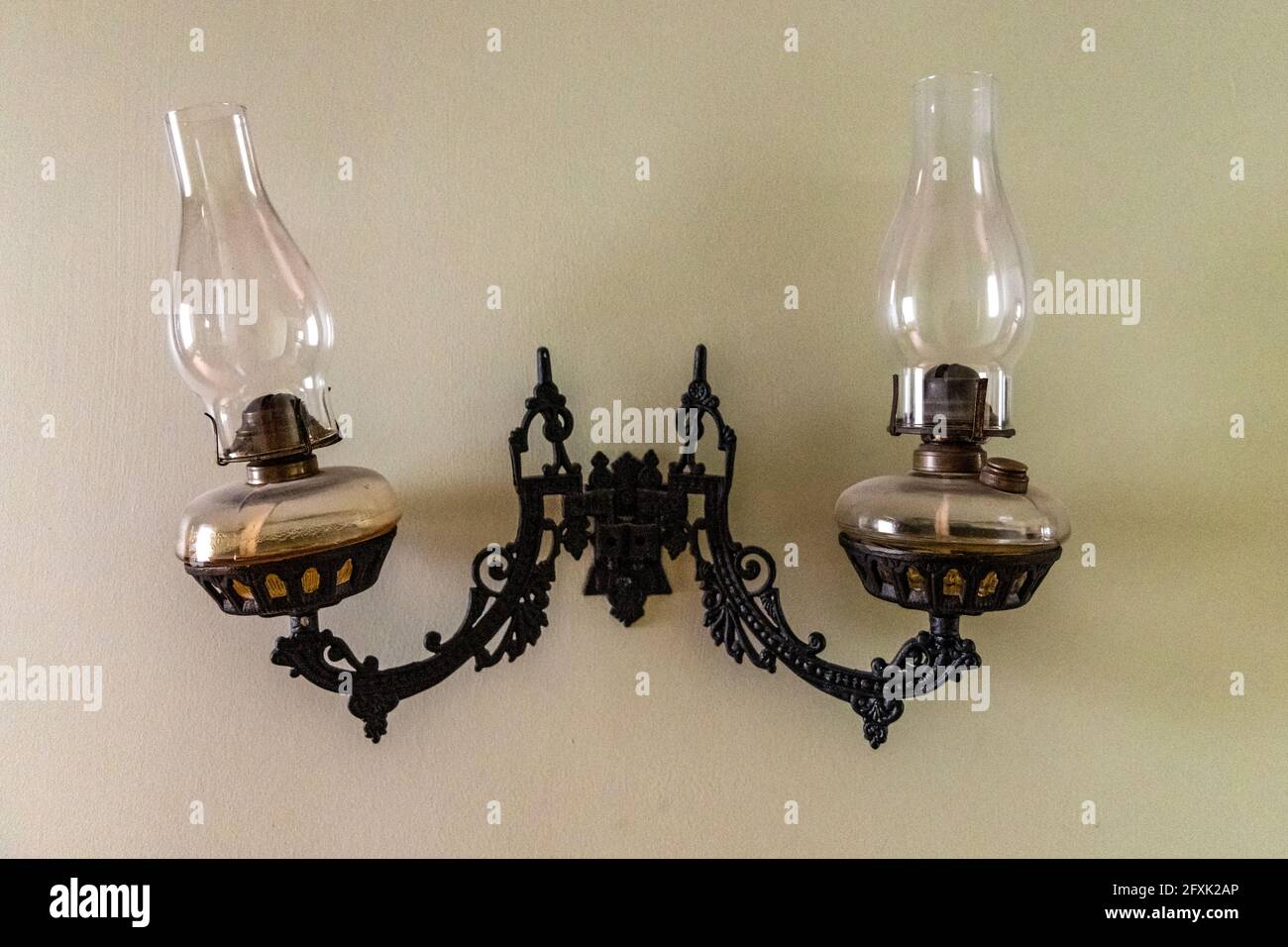 Antique double kerosene lamp in the wall of a colonial style house Stock  Photo - Alamy, image size:1300x956