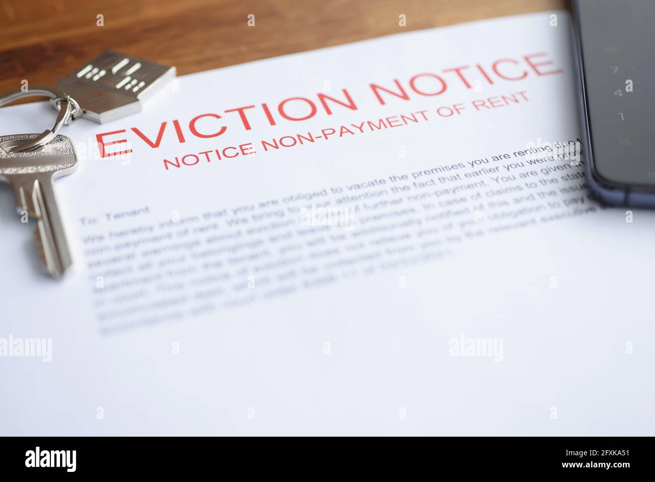 Document on eviction from housing for nonpayment lies on table with