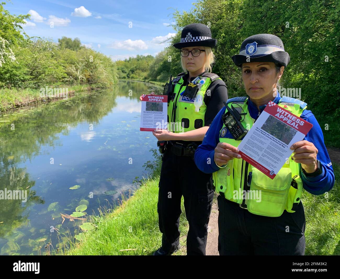 PC Charlotte Gardner and PCSO Suki Lally in rough Wood country park in Walsall, who have been among officers leafleting the local area to raise awareness about the incident where a dead newborn baby boy was found in the local canal. Picture date: Thursday May 27, 2021. Stock Photo