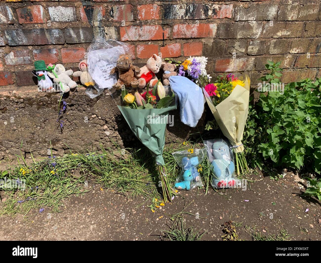 Floral tributes left near Rough Wood country park in Walsall, where a dead newborn baby boy was found in the local canal. Picture date: Thursday May 27, 2021. Stock Photo