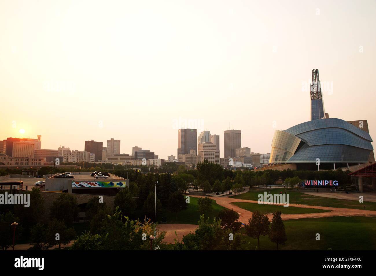 Sunset over the skyline of Winnipeg, Canada. The Canadian Museum for Human Rights stands on the right of the urban scene. Stock Photo