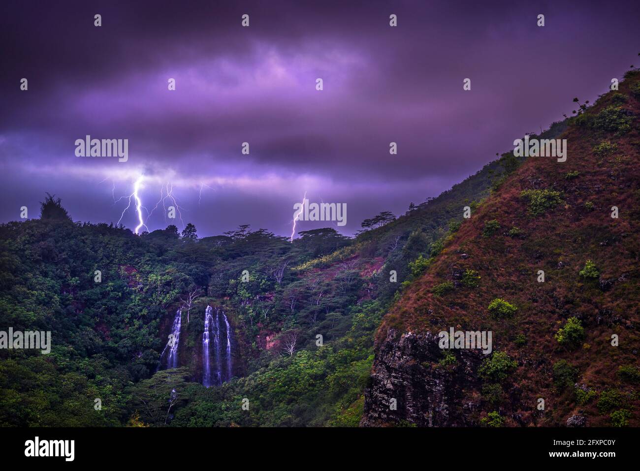 Lightning flashes behind Opekaa Falls, Kauai, Hawaii, United States of America, Pacific Stock Photo