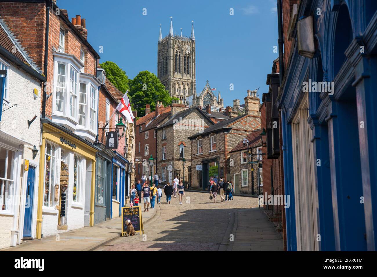 View up The Strait to Steep Hill and the central tower of Lincoln Cathedral, Lincoln, Lincolnshire, England, United Kingdom, Europe Stock Photo