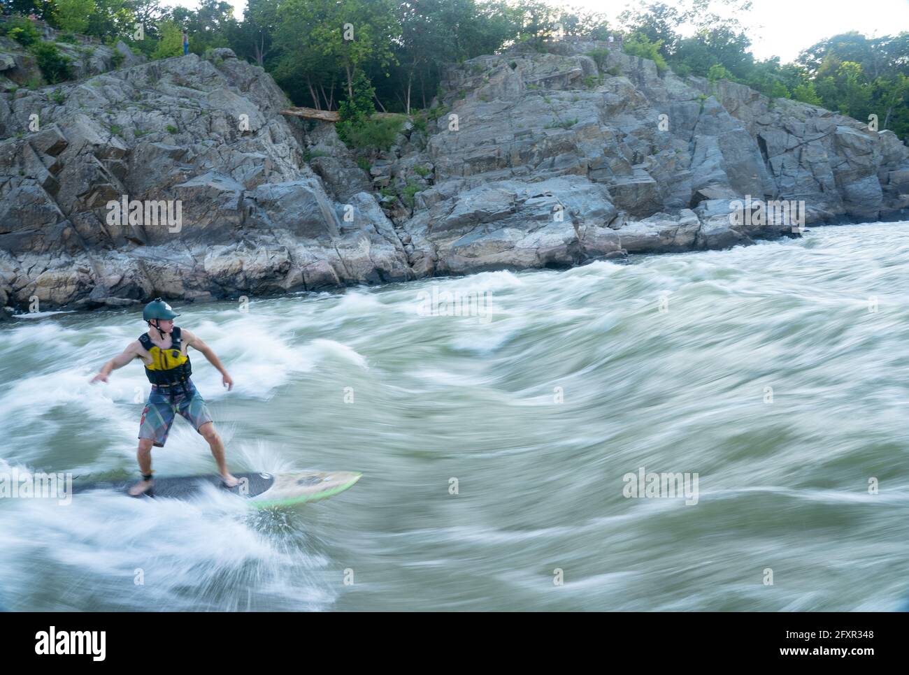 Ian Brown stand up paddle surfs challenging whitewater below Great Falls of the Potomac River, border of Maryland and Virginia, USA, North America Stock Photo