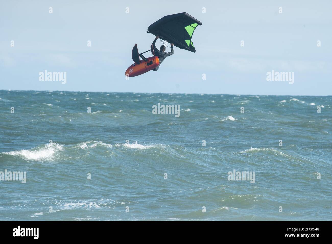 Pro surfer James Jenkins flies above the Atlantic Ocean on his wing surfer at Nags Head, North Carolina, United States of America, North America Stock Photo