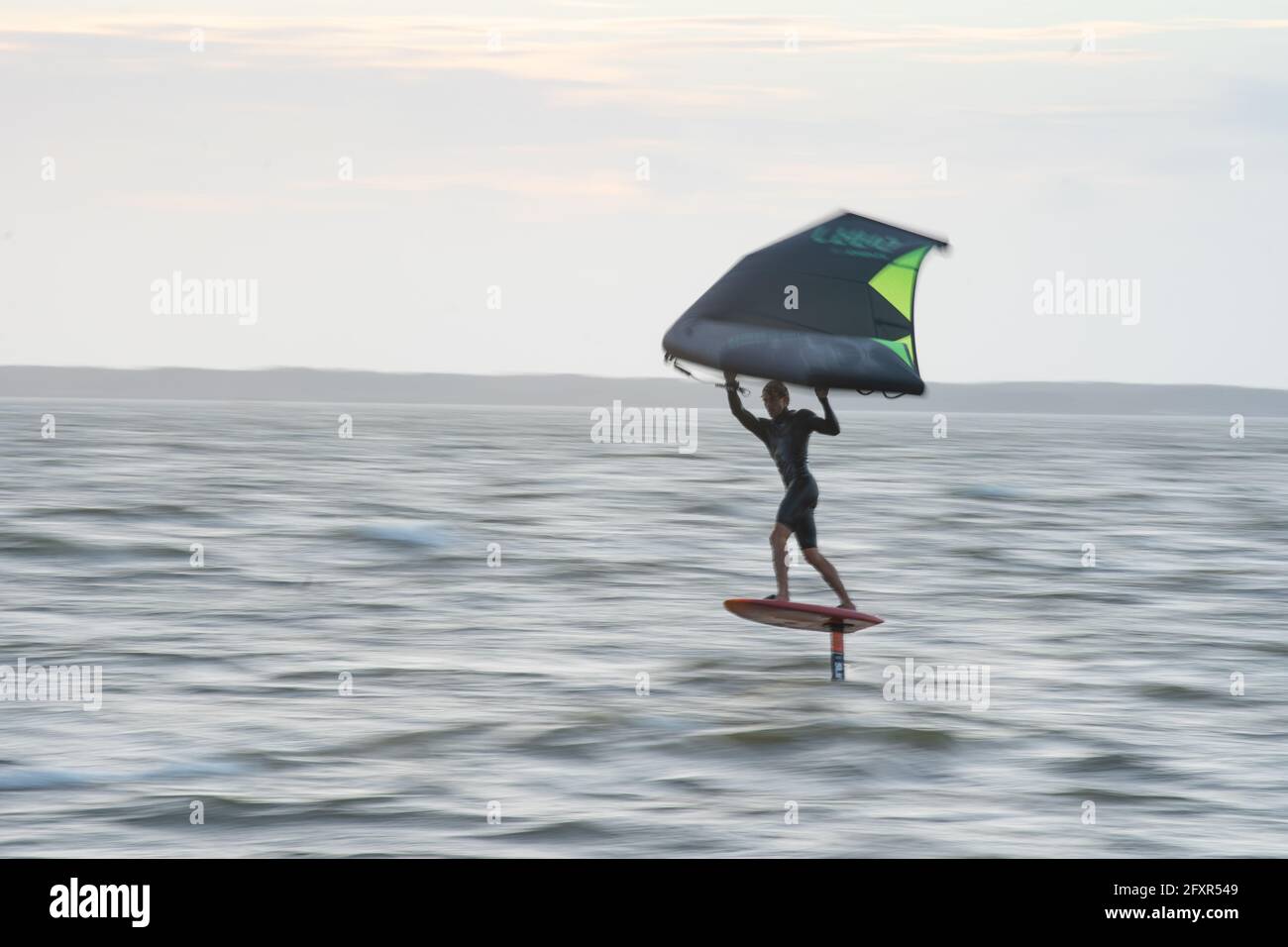 Pro surfer James Jenkins flies above the Atlantic Ocean on his wing surfer at Nags Head, North Carolina, United States of America, North America Stock Photo