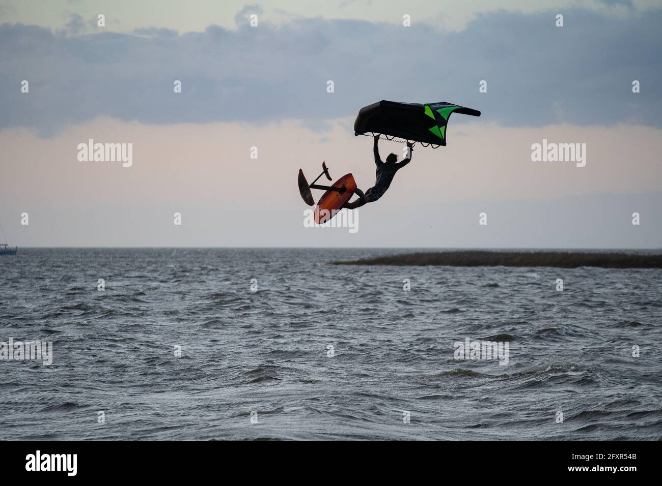 Pro surfer James Jenkins jumps his wing surfer over the Pamlico Sound at Nags Head, North Carolina, United States of America, North America Stock Photo