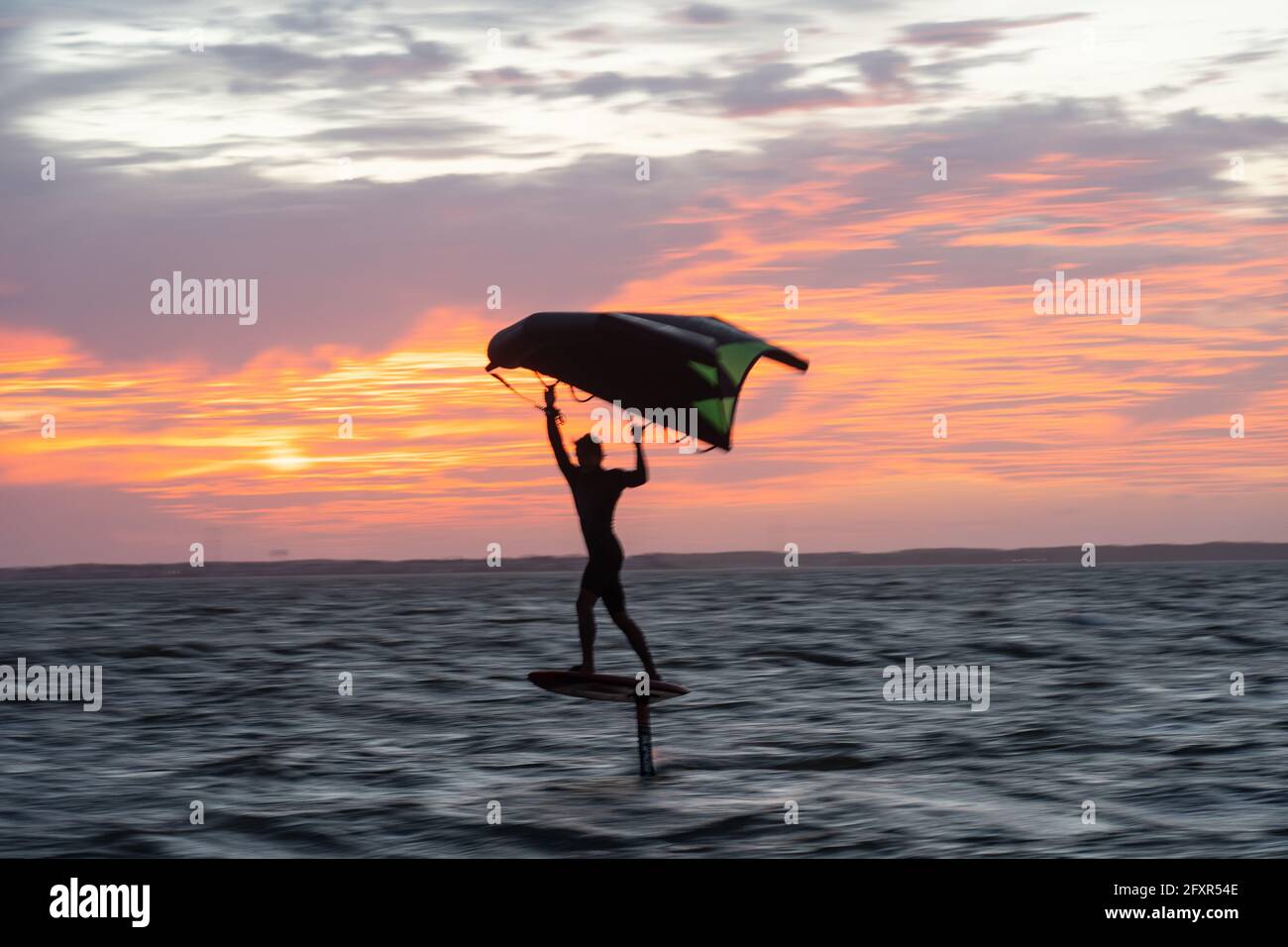 Pro surfer James Jenkins on his wing surfer flies across the Pamlico Sound at Nags Head, North Carolina, United States of America, North America Stock Photo