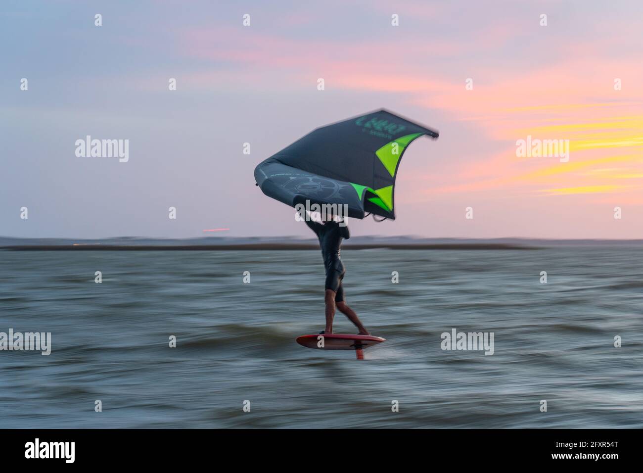 Pro surfer James Jenkins on his wing surfer flies across the Pamlico Sound at Nags Head, North Carolina, United States of America, North America Stock Photo