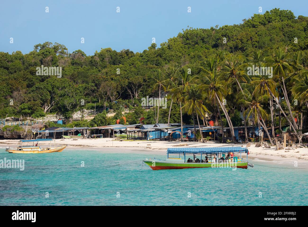 Tourist dive boat moored by white sand Bira Beach at far South resort town, Tanjung Bira, South Sulawesi, Indonesia, Southeast Asia, Asia Stock Photo